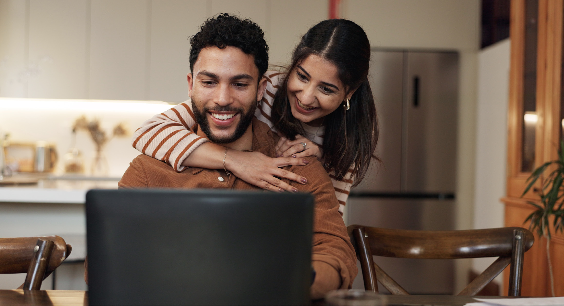 A couple reviewing finances together at a laptop