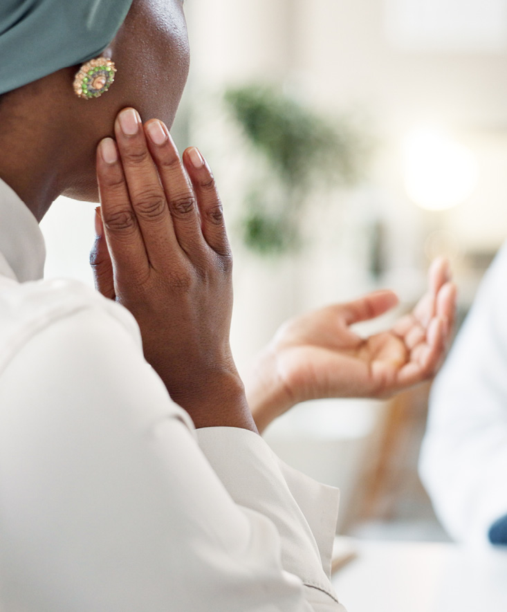A patient touching their jaw
